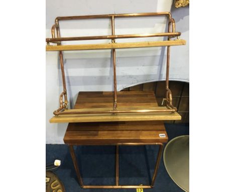 A copper pipework two tier shelf and a small table