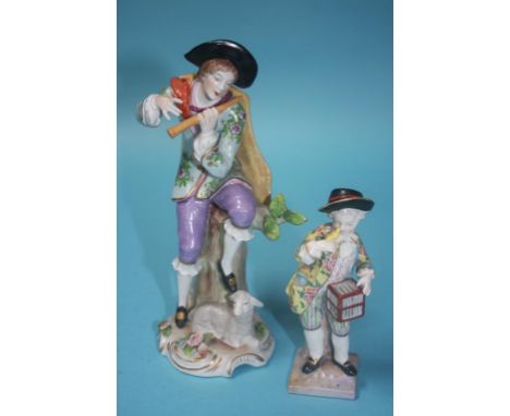 A Continental porcelain figure of a young man playing a flute and a small figure of a boy holding a canary and a bird cage