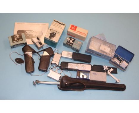 Three Minox 'Spy' cameras, with assorted accessories