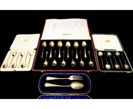 A collection of silver flatware including:  A boxed set of six tea and six coffee spoons, each struck with different Assay of