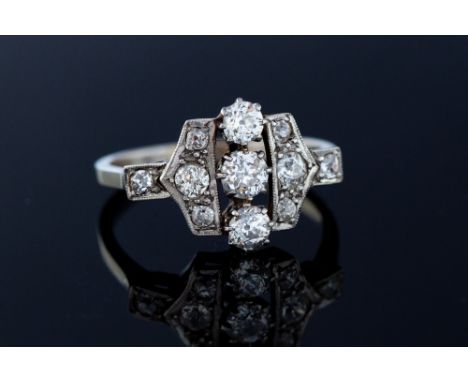 An Art Deco diamond set platinum and white gold ring, the geometric design head set with round old cut diamonds with a total 