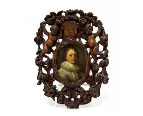 A 17th century oval portrait miniature of a young gentleman, bust length wearing a white ruff, oil on copper, set in a Grinli