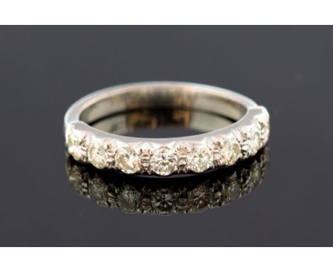 A half-hoop diamond ring, with eight brilliant-cut diamonds in white metal mount, shank stamped '18ct', total diamond weight 