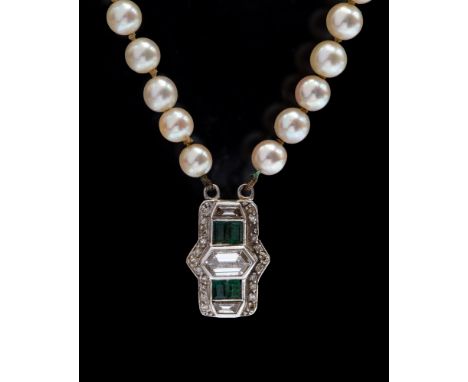 An Art Deco  double row graduated cultured pearl necklace with an emerald and diamond clasp, the round cultured pearls gradua