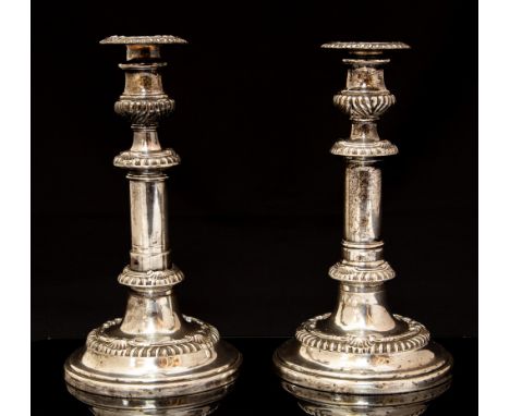 A pair of early 19th Century Old Sheffield plate telescopic candlesticks, campana shaped nozzles above gadroon sections, deta