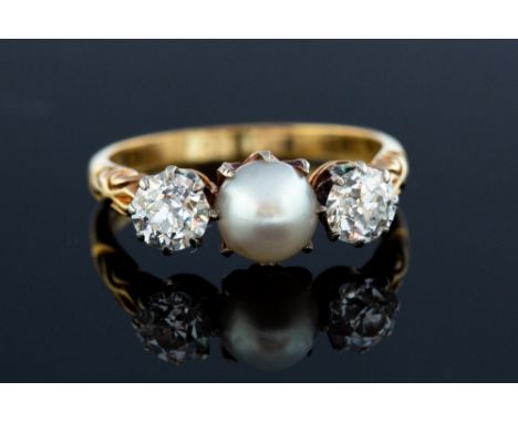 A Victorian  pearl and diamond  three stone ring, the central button shaped pearl approx 6.5mm diameter, two round old cut di