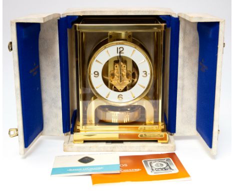 A Jaeger Le Couture Atmos bracket timepiece, polished brass case with glazed sides and top, white chapter ring with dagger an