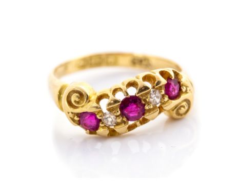 A Victorian ruby and diamond five stone Etruscan style 18 carat gold ring, with scroll swirl detail, ring size J, gross weigh