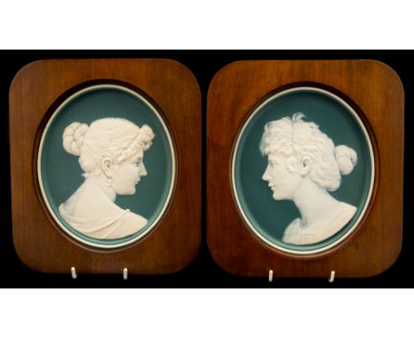 A pair of late 19th Century Mettlach pate sur pate oval wall plaques, each with the profile portrait of a beautiful young lad