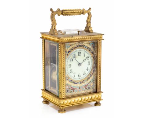 A late 19th Century French gilt metal repeating carriage clock, corniche case with visible escapement, white enamel dial with