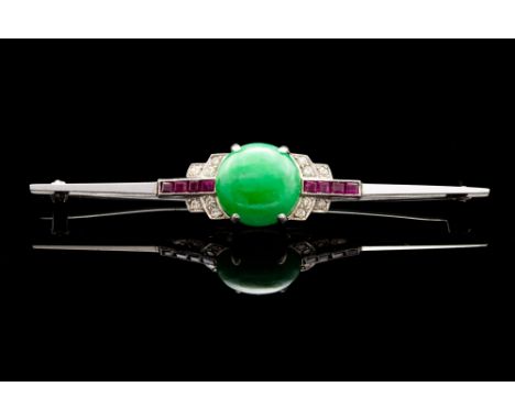 An Art Deco jadeite, ruby and diamond set 18ct white gold and platinum bar brooch, the central cabachon cut jadeite 11mm diam