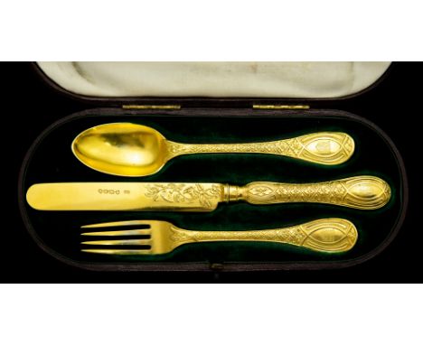 A Victorian silver-gilt three-piece Christening set, each handle engraved with coat-of-arms, in fitted case, George Adams,&nb