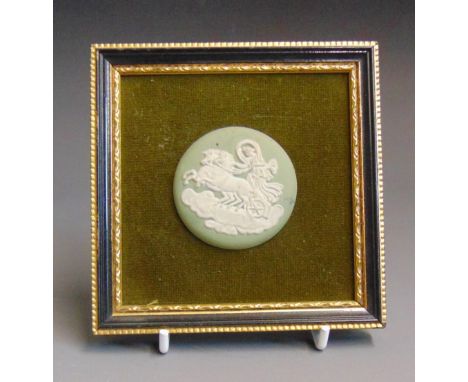 A Wedgwood green jasper round medallion of Aurora or The Goddess of Dawn. mounted in a black and gilt frame on a green velvet