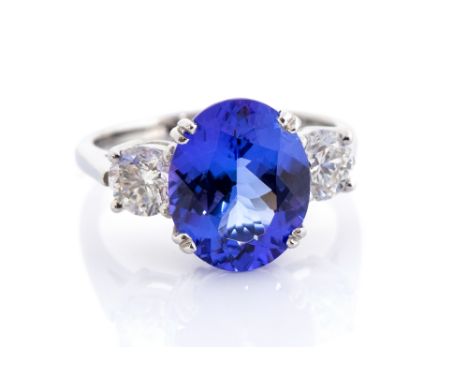 ***POSTED BACK TO CLIENT 19/12/18 AN*** A tanzanite and diamond ring, the oval split claw set tanzanite approx. 4.25ct, with 