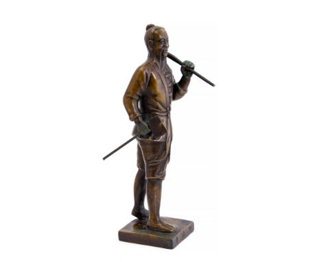 A Chinese Republic period bronzed figure of a bearded workman, standing holding the tools of his trade, square plinth, triple