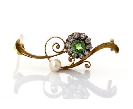 An Edwardian peridot, diamond and pearl bar brooch, the round-cut peridot surrounded by ten round old-cut diamonds, the scrol