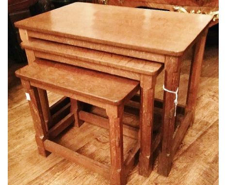 Robert 'Mouseman' Thompson, a Mouseman nest of three joined oak tables, each with adze tops, largest table measuring 45cm hig