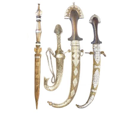 Four African daggers Four African daggers, including a Toreg brass, dagger with horn, bone, copper, and pewter inserts, also 