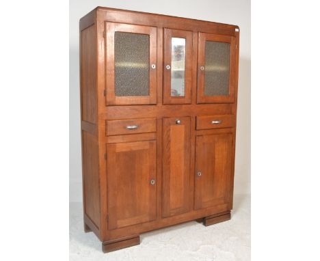 A superb 1930's early 20th century art deco antique vintage oak kitchen larder cabinet having three cupboards to top with mir