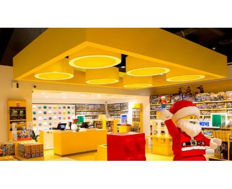 Lego - A set of four large Lego Store ceiling light fixtures of medallion form in the Lego brick yellow. The shades come apar