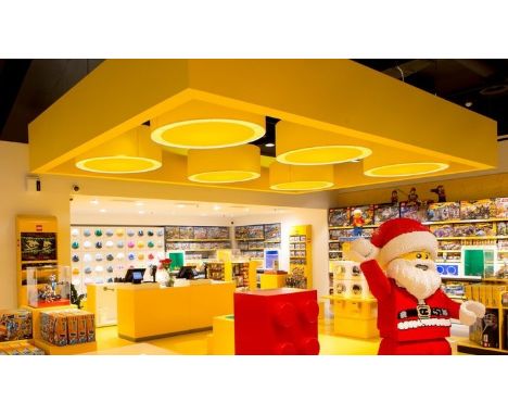 Lego - A set of four large Lego Store ceiling light fixtures of medallion form in the Lego brick yellow. The shades come apar