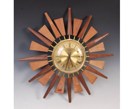 Anstey &amp; Wilson - A 20th Century retro vintage sunburst wall clock of teak and gilt brass construction. The central circu