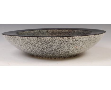 A stunning large 20th century ceramic centrepiece / console bowl of geode form having a speckled stone interior and exterior 