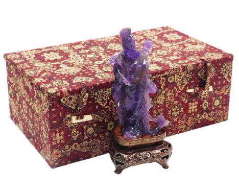 A 20thC Chinese amethyst quartz figure of a lady, modelled standing holding a pipa, or lute, with stand, boxed, 12.5cm high.