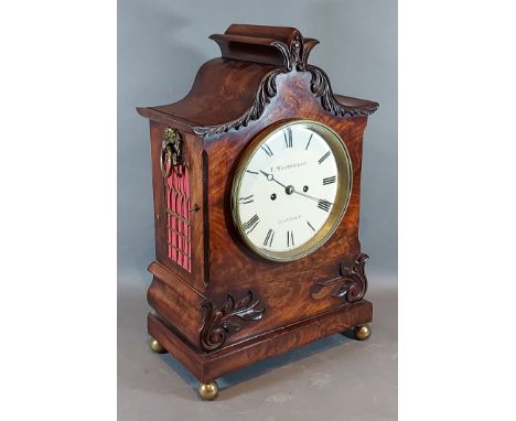 A William IV mahogany case bracket clock, the carved shaped case with side ring handles, the dial inscribed T. Whitehead, Lon