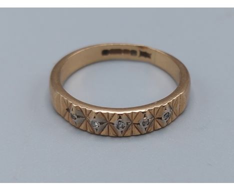 A 9ct gold ring set with five Diamonds, ring size M, 2.2gms 