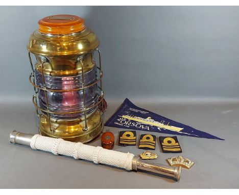 A brass and glass ships lamp together with a telescope by Gieves, Ltd, a cap badge, three shoulder Insignia and a brass paper