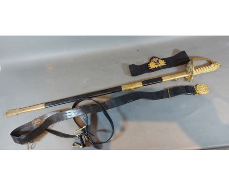 A Royal Navy Officers sword with brass hilt and leather scabbard together with belt and hanger 