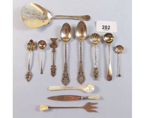 A silver bookmark with mother of pearl handle, a silver salt spoon, a silver pickle fork and a pierced silver bowl and spoon