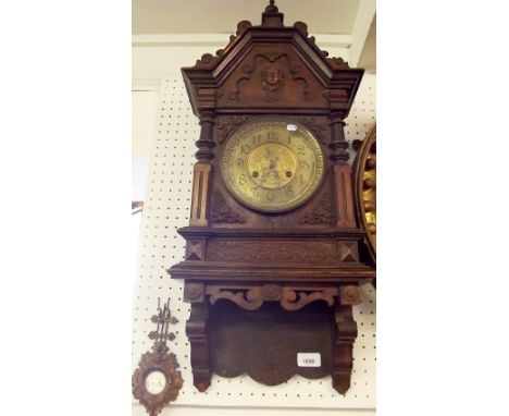A Victorian architectural style mahogany wall clock with carved decoration and gilt face