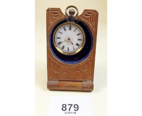 A Swiss carved treen watch stand and watch with enamel face