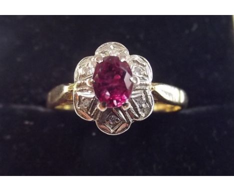 A 9ct gold ruby and chip diamond cluster ring - Size L 1/2