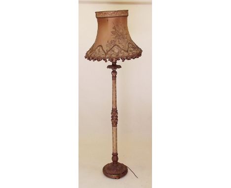 A carved gilt wood and fabric covered standard lamp and shade