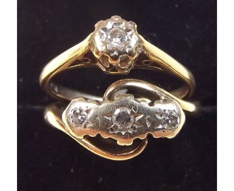 A 9 carat gold diamond solitaire ring and a 9 carat gold three stone diamond crossover ring