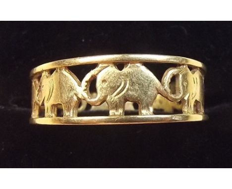 An 18 carat gold ring with pierced band of elephants, 3g