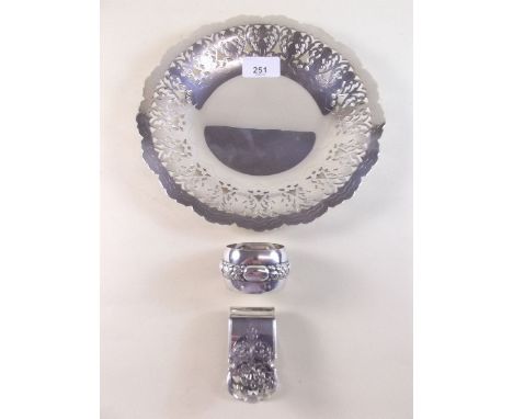 A white metal napkin clip and a napkin ring stamped Kraft Alpacca, plus a silver plated dish with fretwork design