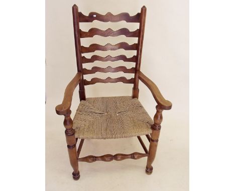 A ladder back carver chair on turned supports
