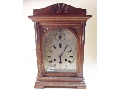 A large Victorian oak cased mantel clock with silvered dial 43cm tall