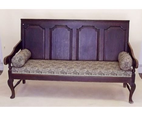 An 18th century four panel back bench raised on cabriole supports