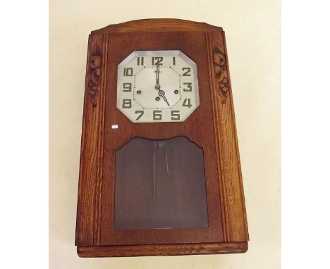 A French oak cased Art Deco wall clock by Girod with choice of chime, pendulum and key