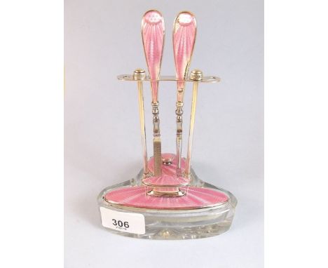 A silver and pink enamel manicure set