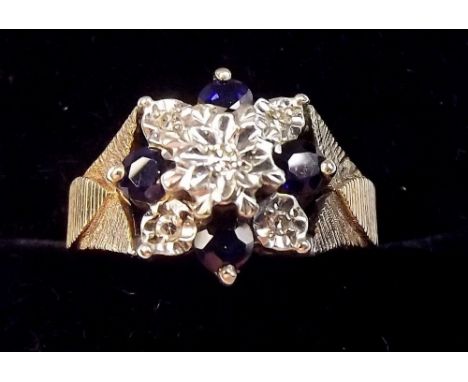 A 9 carat gold sapphire and diamond flower form ring