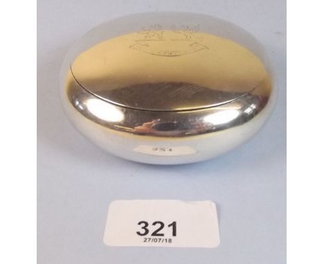 A silver oval snuff box with engraved crest 
