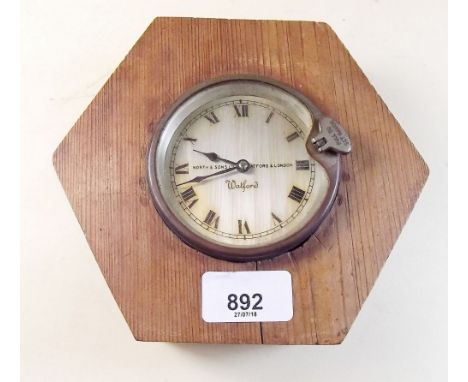 A North and Sons Watford car clock - later mounted in wood