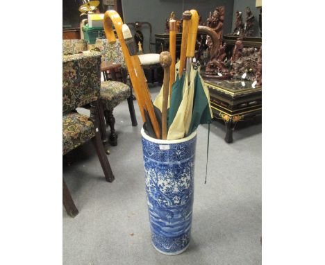 A Chinese blue and white vase as a stick stand and a quantity of sticks  