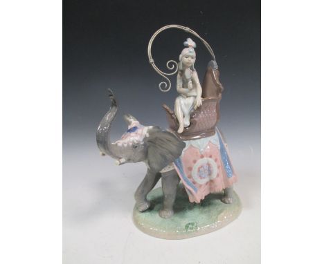 A Lladro figure of a lady on an elephant, by R Torrijos, 40 cm high  